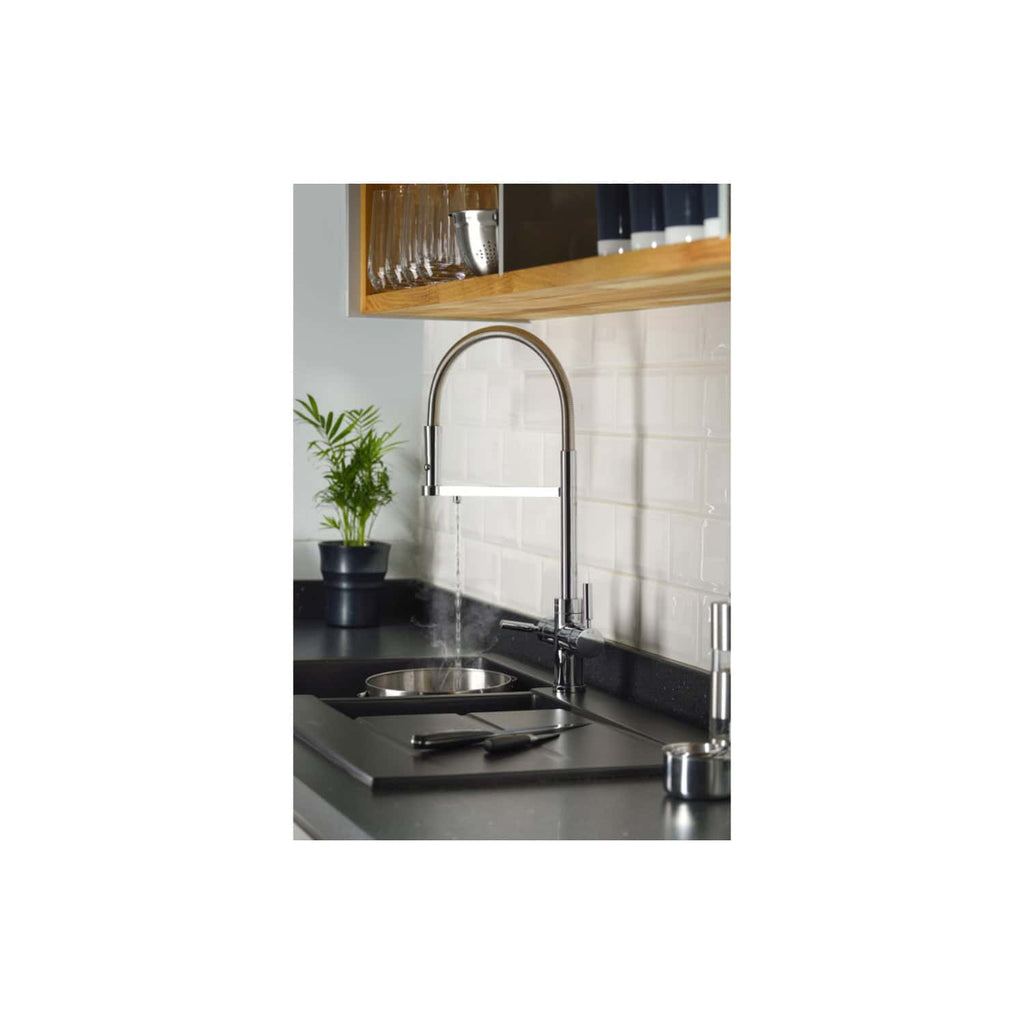 Sleek kitchen sink with chrome faucet, black countertop, white backsplash tiles, wooden shelves, and a small potted plant for modern bathroom or kitchen design.