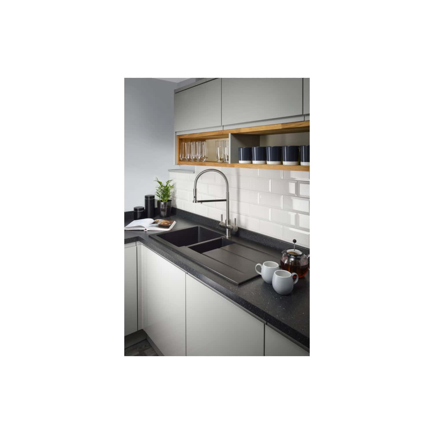 Sleek modern kitchen with black double sink, white cabinetry, open wooden shelving, glassware, mugs, and decorative accents perfect for contemporary kitchen design.