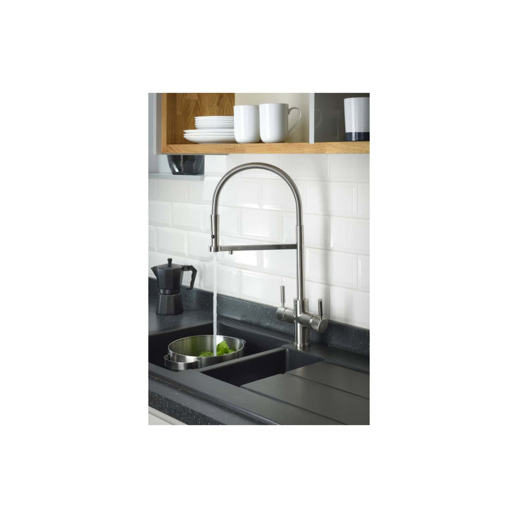Shiny stainless steel kitchen tap with a high arc, installed over a black composite sink with a draining cover, against a white subway tile backsplash, in a modern kitchen setting.