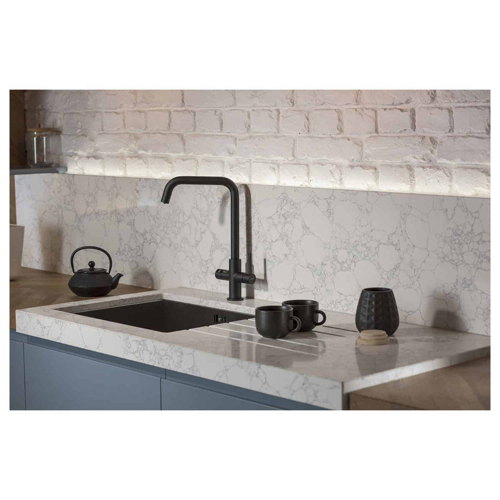 Sleek modern kitchen with marble worktop, black faucet, and minimalist decor, showcasing high-quality Bubly Bathrooms kitchen fixtures and fittings.