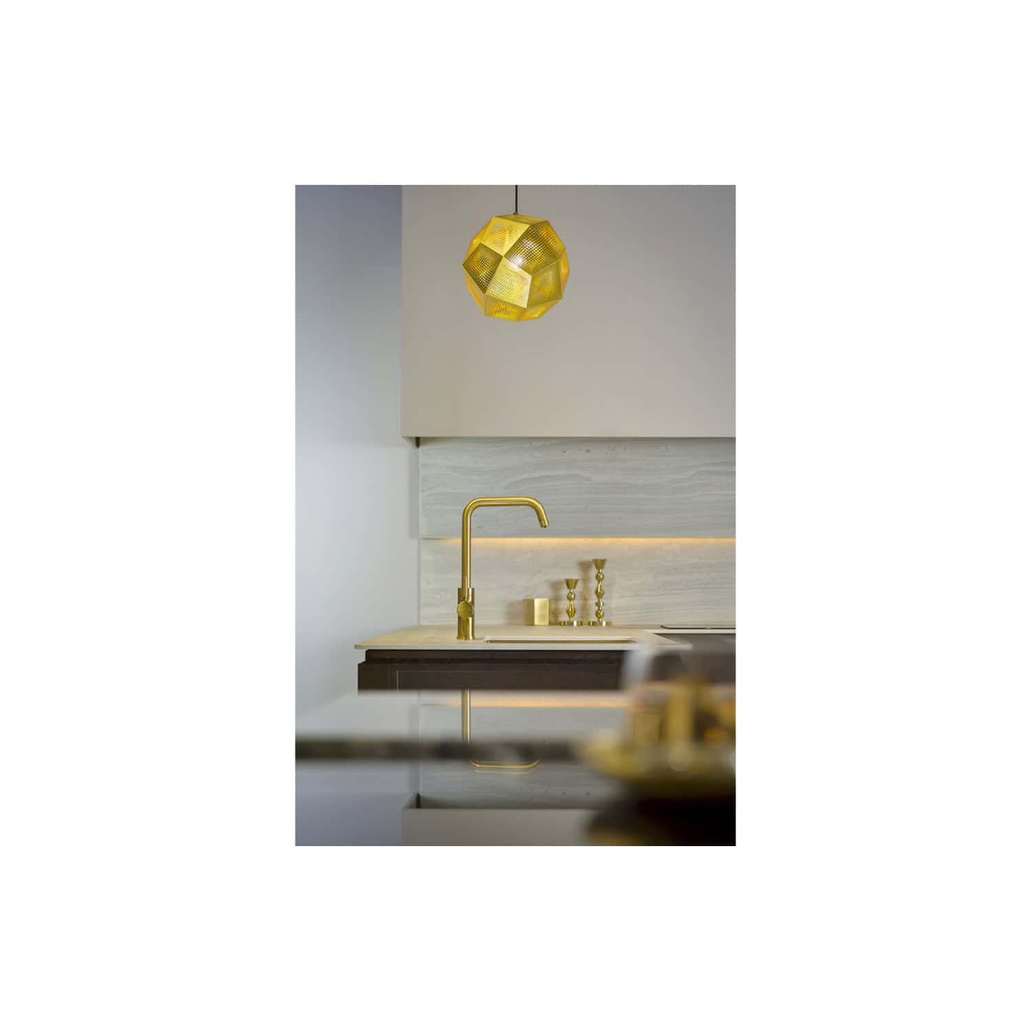 Gold kitchen tap with modern design and stylish lighting in a contemporary kitchen setting, featuring minimalist decor and elegant accents, ideal for aspiring home renovators and interior design enthusiasts.