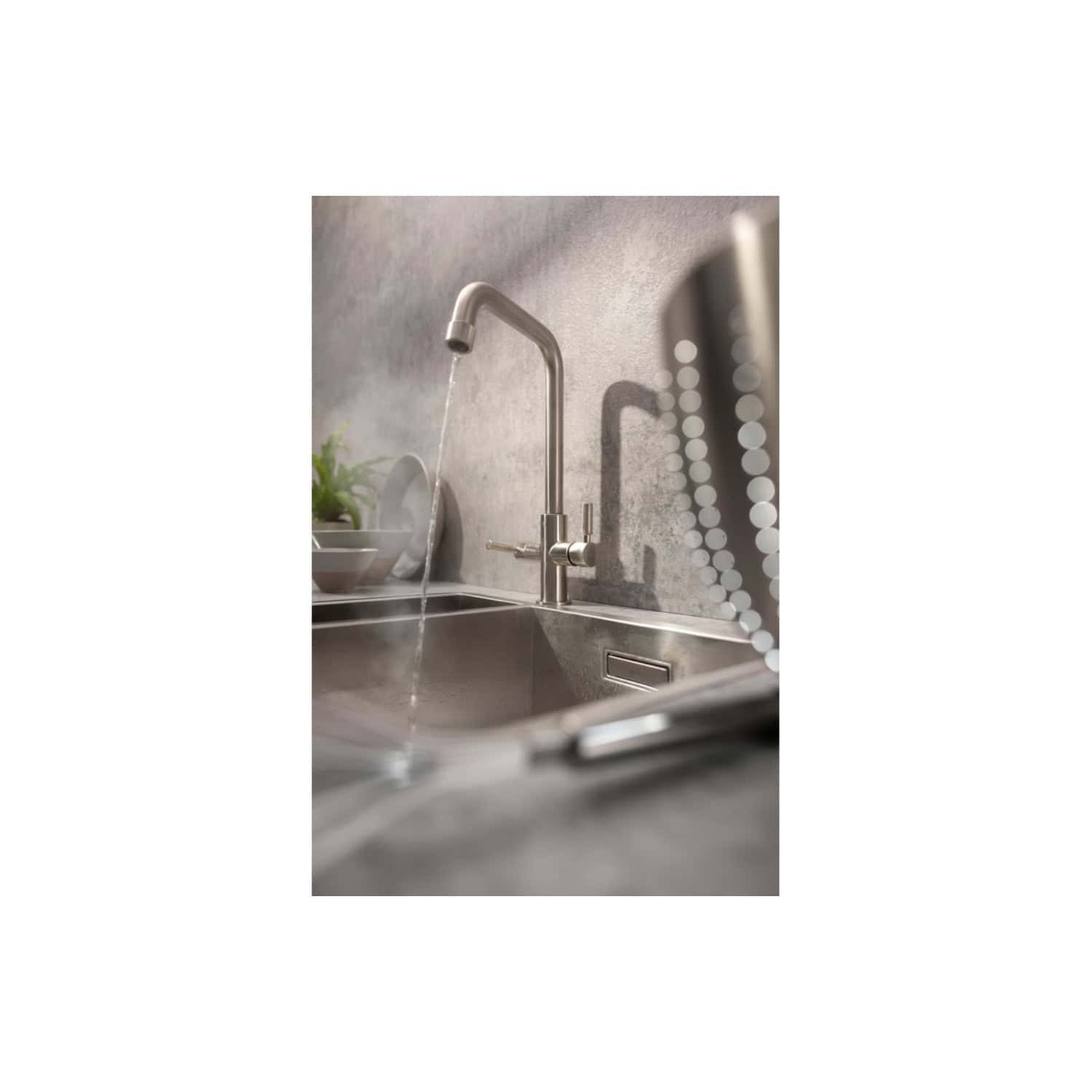 Shiny stainless steel kitchen sink with modern gooseneck faucet in a contemporary bathroom setting. The sink features a sleek design with clean lines, perfect for modern bathroom decor.