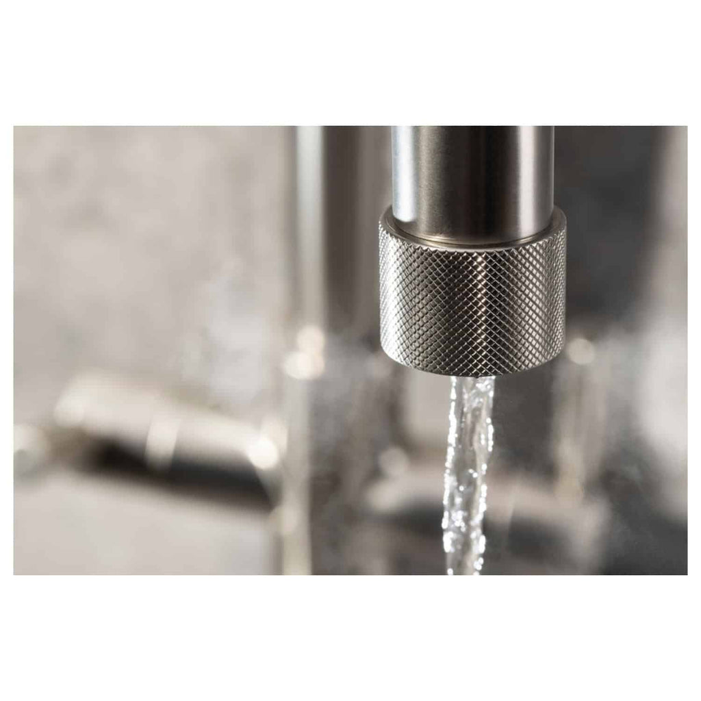 Shiny stainless steel kitchen tap with a water stream flowing, modern plumbing fixture for bathrooms or kitchens. High-quality bathroom and kitchen fittings from Bubly Bathrooms.