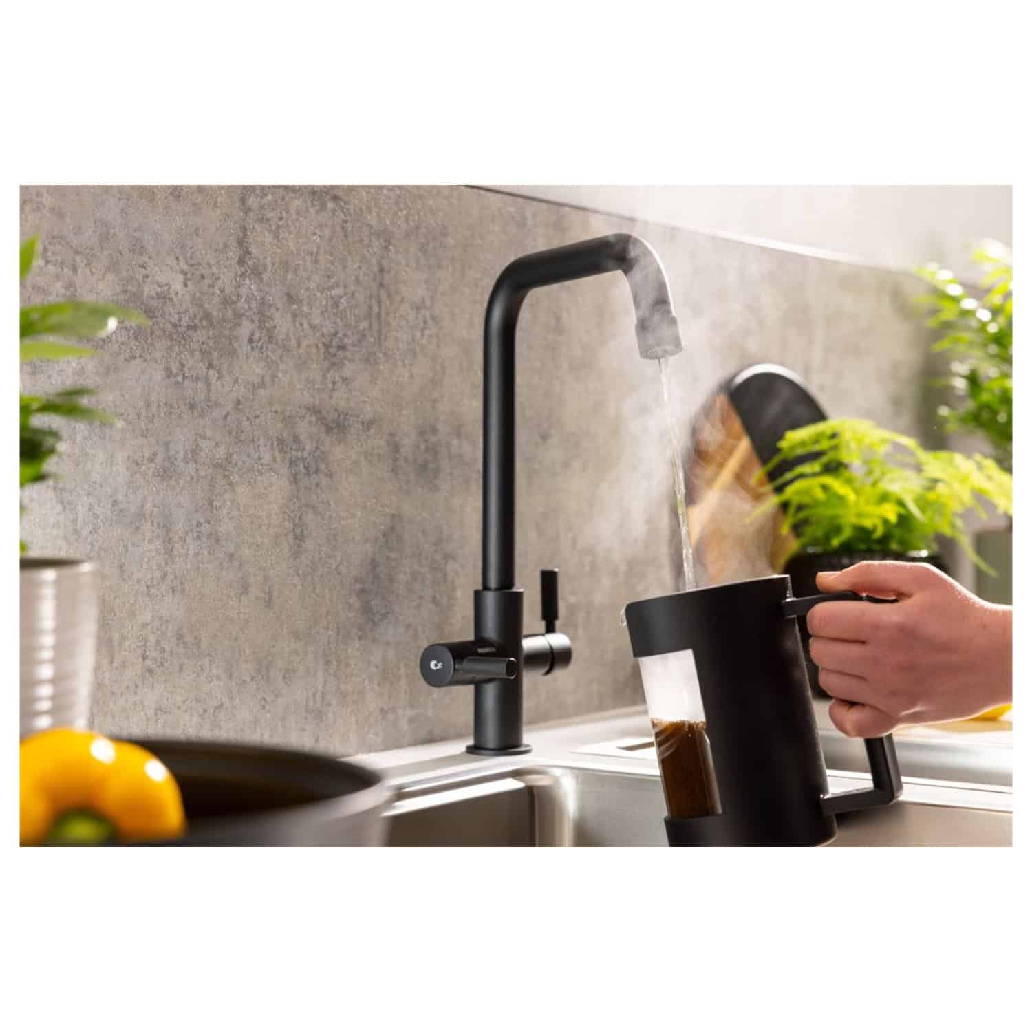 Sleek black kitchen tap with modern design, high arc, and pull-down spout installed over a stainless steel sink in a contemporary kitchen setting.