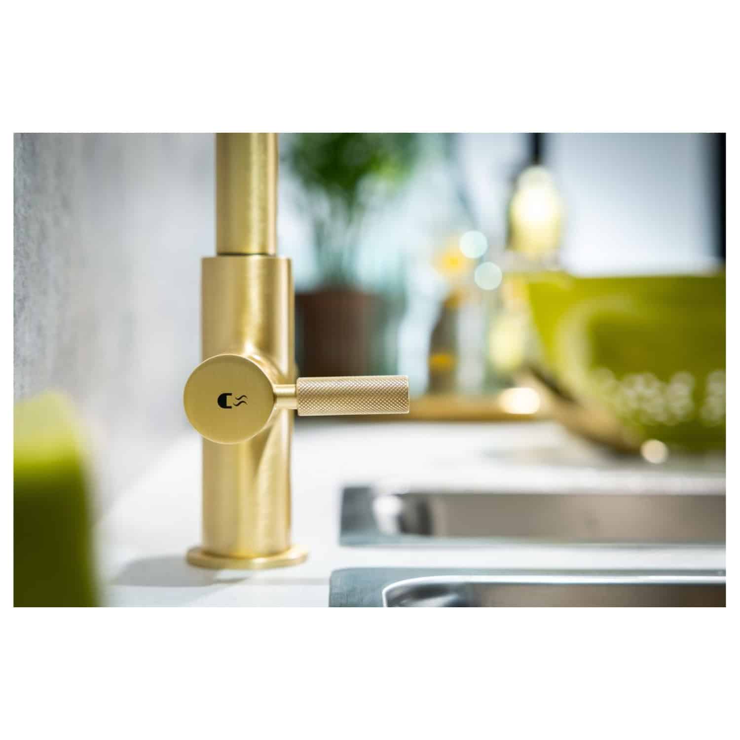 Sleek gold kitchen tap with modern design, close-up shot showcasing luxury bathroom fixtures. Perfect for contemporary Bubly Bathrooms interiors and kitchen renovation ideas.