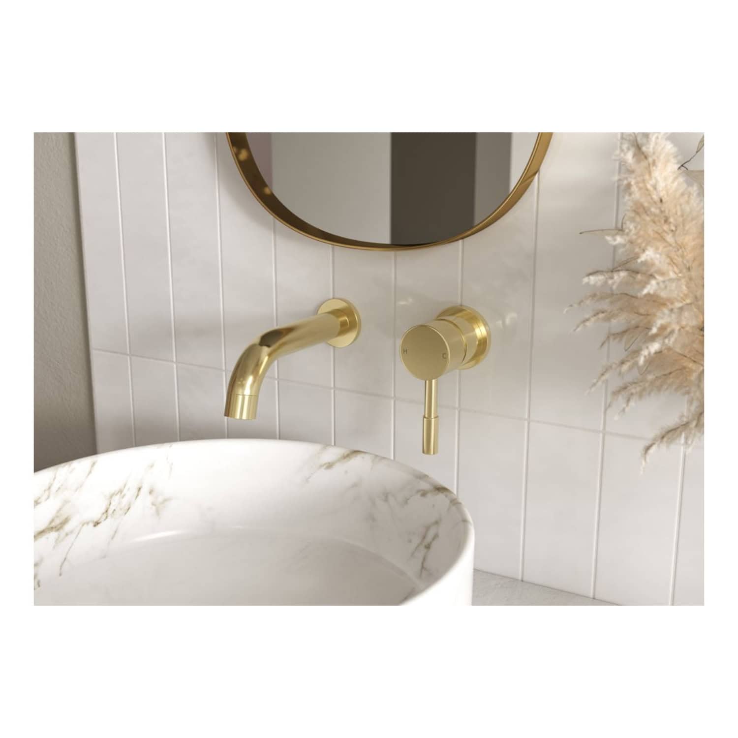 Sleek gold wall-mounted bathroom sink tap with modern design, paired with a marble bowl sink and a round mirror, creating a luxurious and stylish bathroom setting.