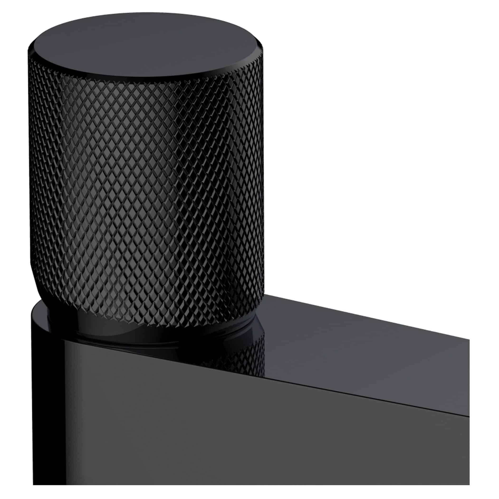 Black cylindrical smart speaker with textured mesh surface on a sleek black surface, modern bathroom or kitchen decor, high-quality audio device.