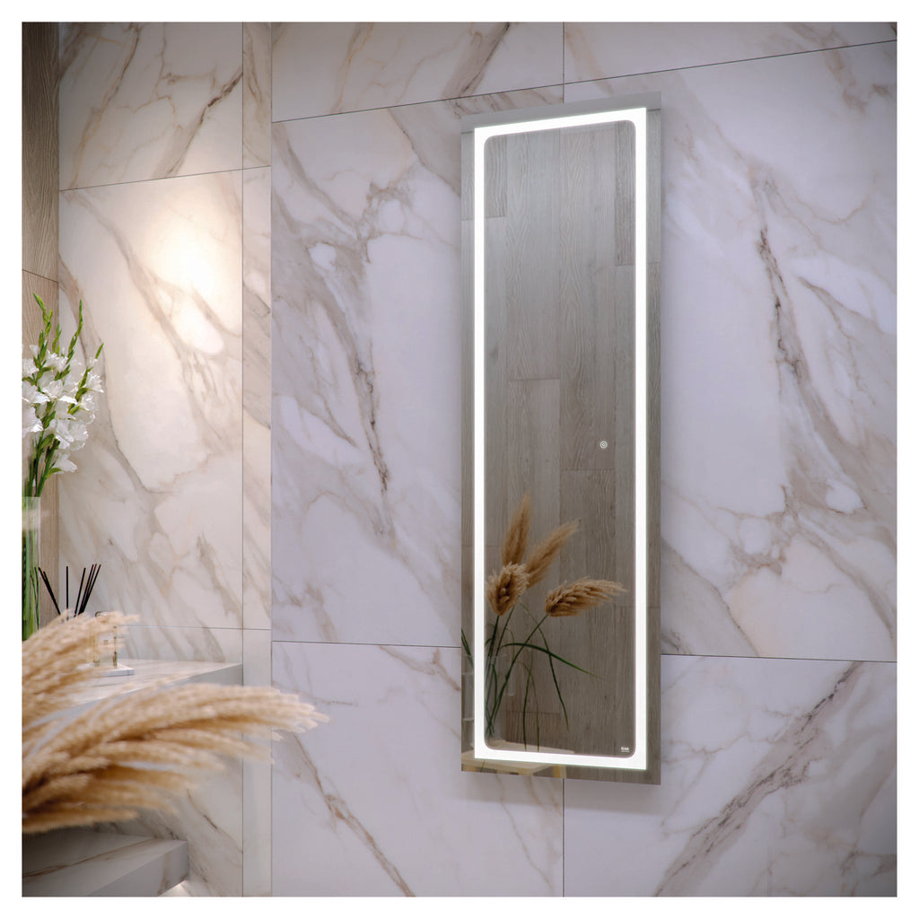 Modern illuminated bathroom mirror with LED lighting, mounted on marble-effect wall tiles in a contemporary bathroom setting.