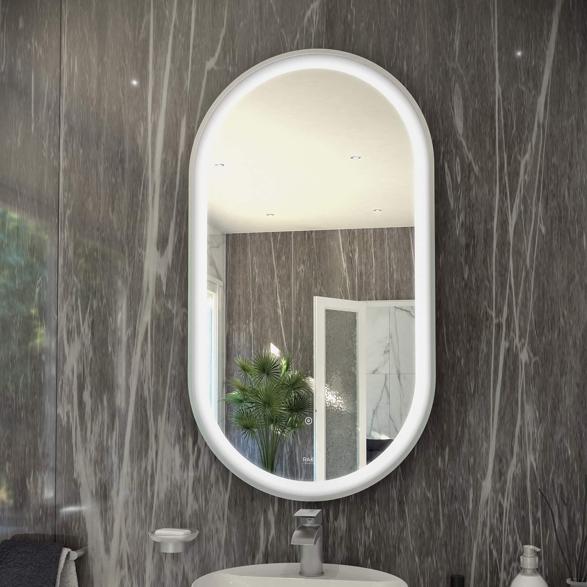 Sleek oval bathroom mirror with built-in LED lighting reflecting a modern, stylish bathroom with grey marble walls and decorative elements. Ideal for contemporary bathroom decor and renovation.