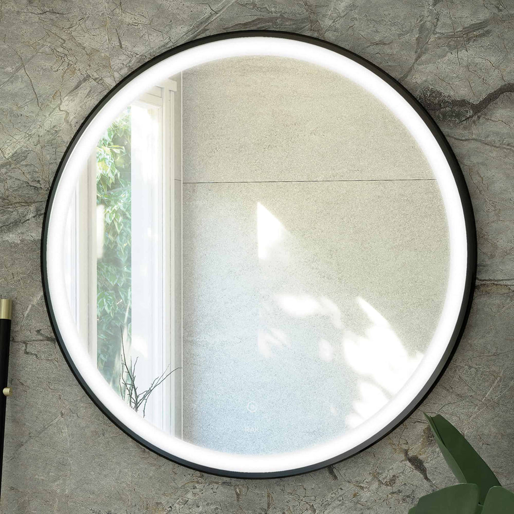 Bright round LED bathroom mirror with illuminated edge, mounted on a textured stone wall, reflecting natural light from a nearby window. Perfect for modern bathroom decor and grooming routines.