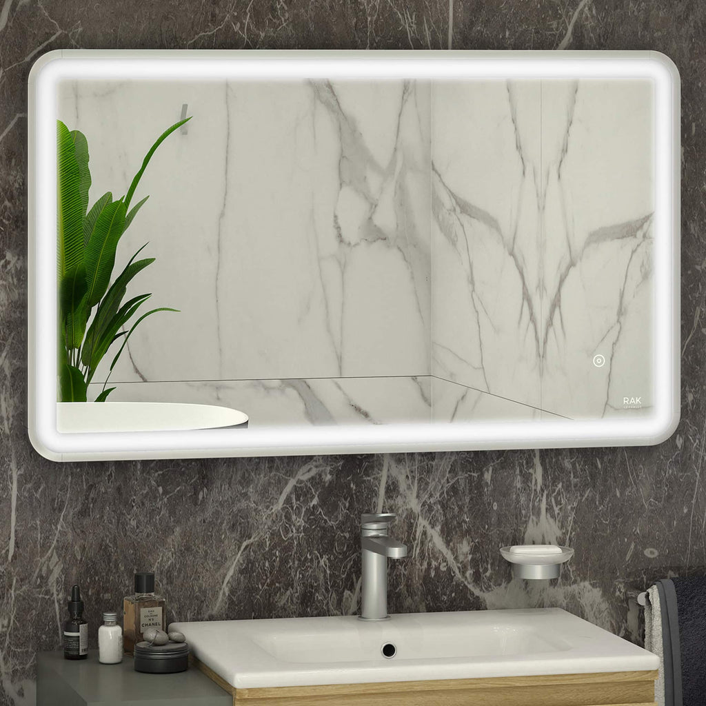 Modern illuminated bathroom mirror with LED backlighting over a marble wall vanity with sink and accessories, stylish design, perfect for contemporary bathroom decor.