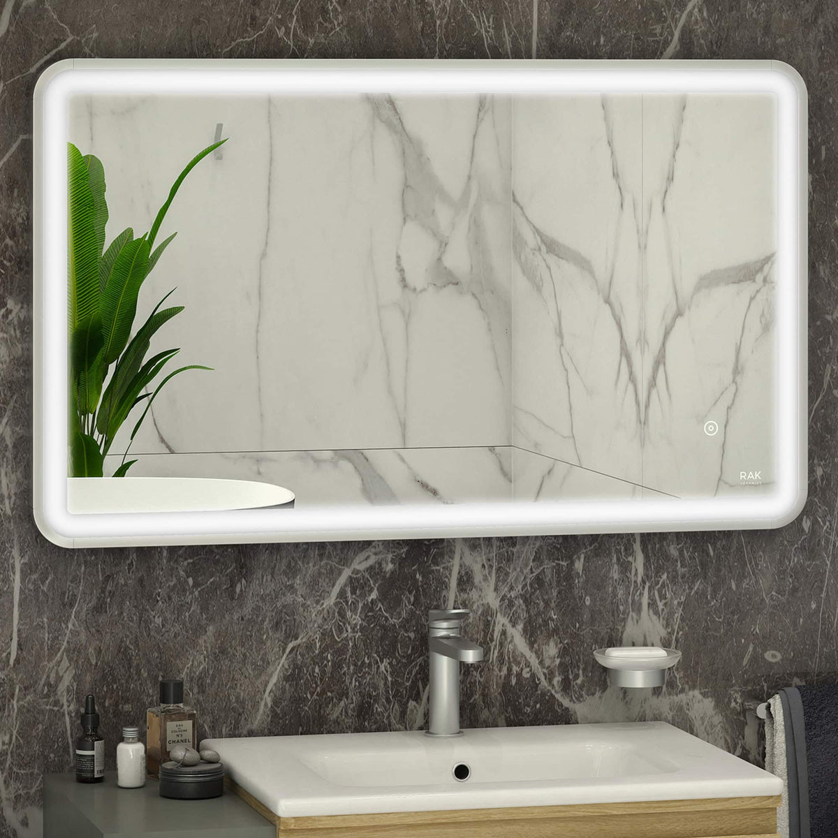 Modern illuminated bathroom mirror with LED backlighting over a marble wall vanity with sink and accessories, stylish design, perfect for contemporary bathroom decor.