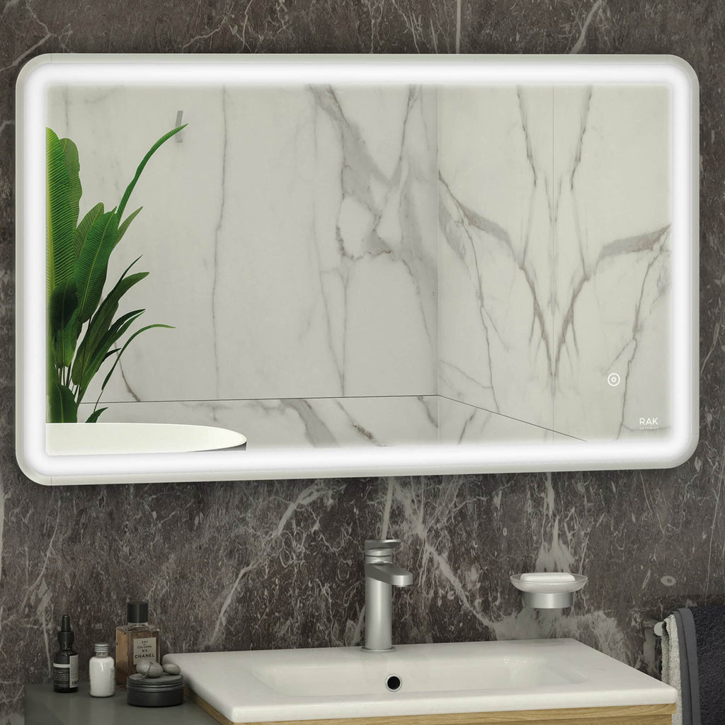 Sleek illuminated bathroom mirror with backlit LED lighting, set against a marble wall, complemented by modern bathroom accessories and lush green plant for a luxurious bathroom upgrade.