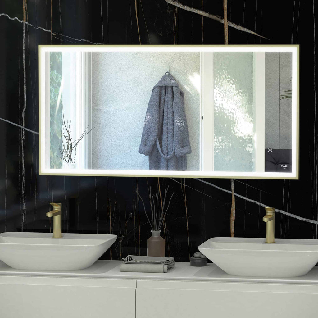 Contemporary bathroom vanity with dual white vessel sinks, sleek gold taps, and a large backlit mirror, creating a modern and elegant space for grooming and relaxation.