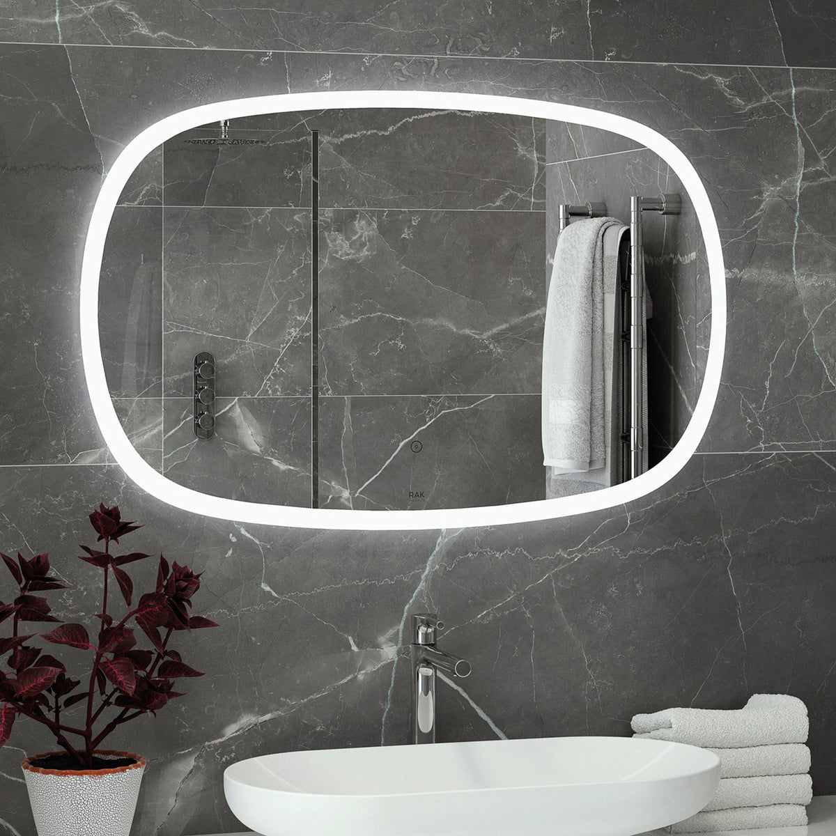 Polished grey marble bathroom with illuminated oval mirror, modern shower enclosure, and minimalist white basin, showcasing luxury bathroom design and fixtures from Bubly Bathrooms.