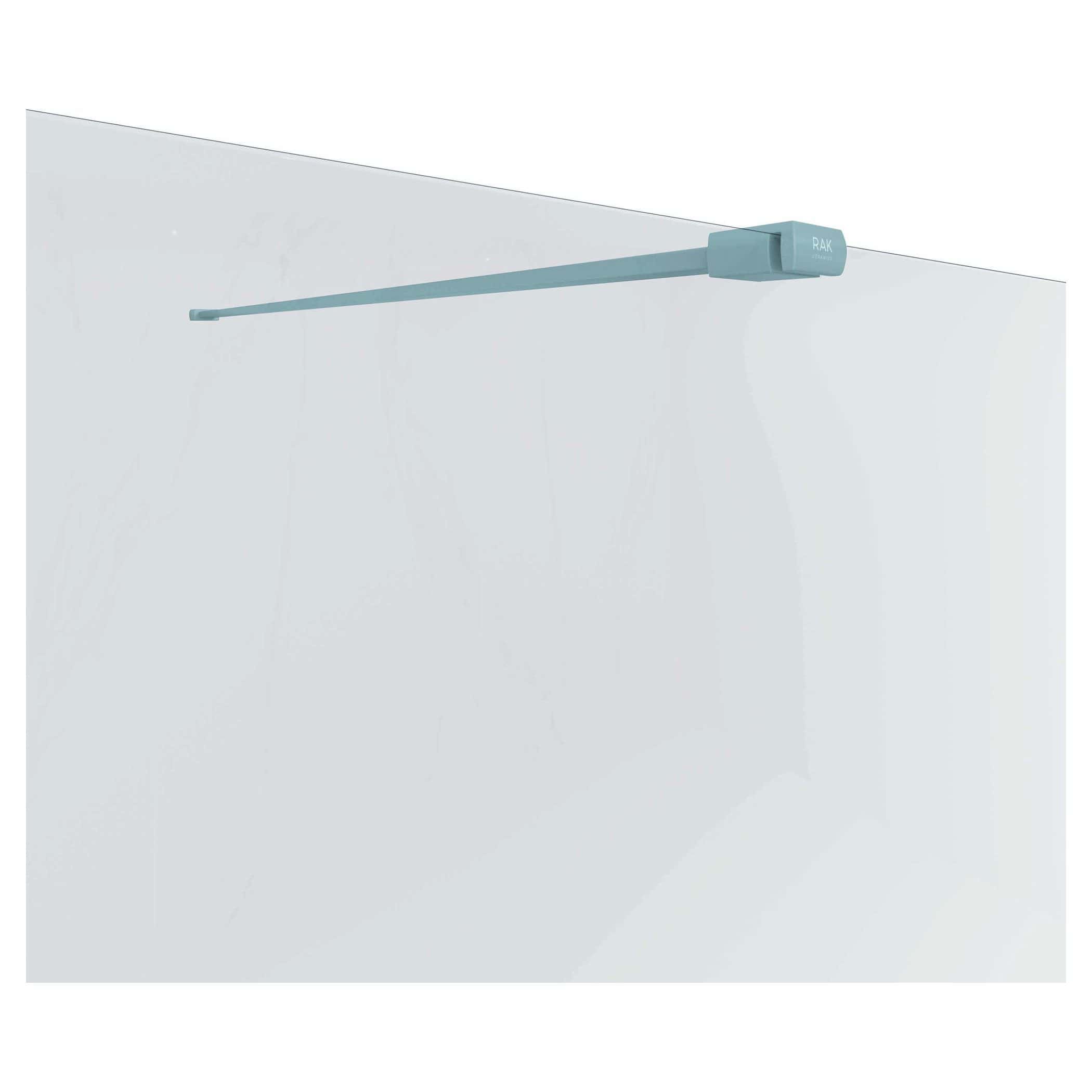 Light blue RAK retractable clothes drying rail installed on a plain white bathroom wall for space-saving laundry drying solutions.