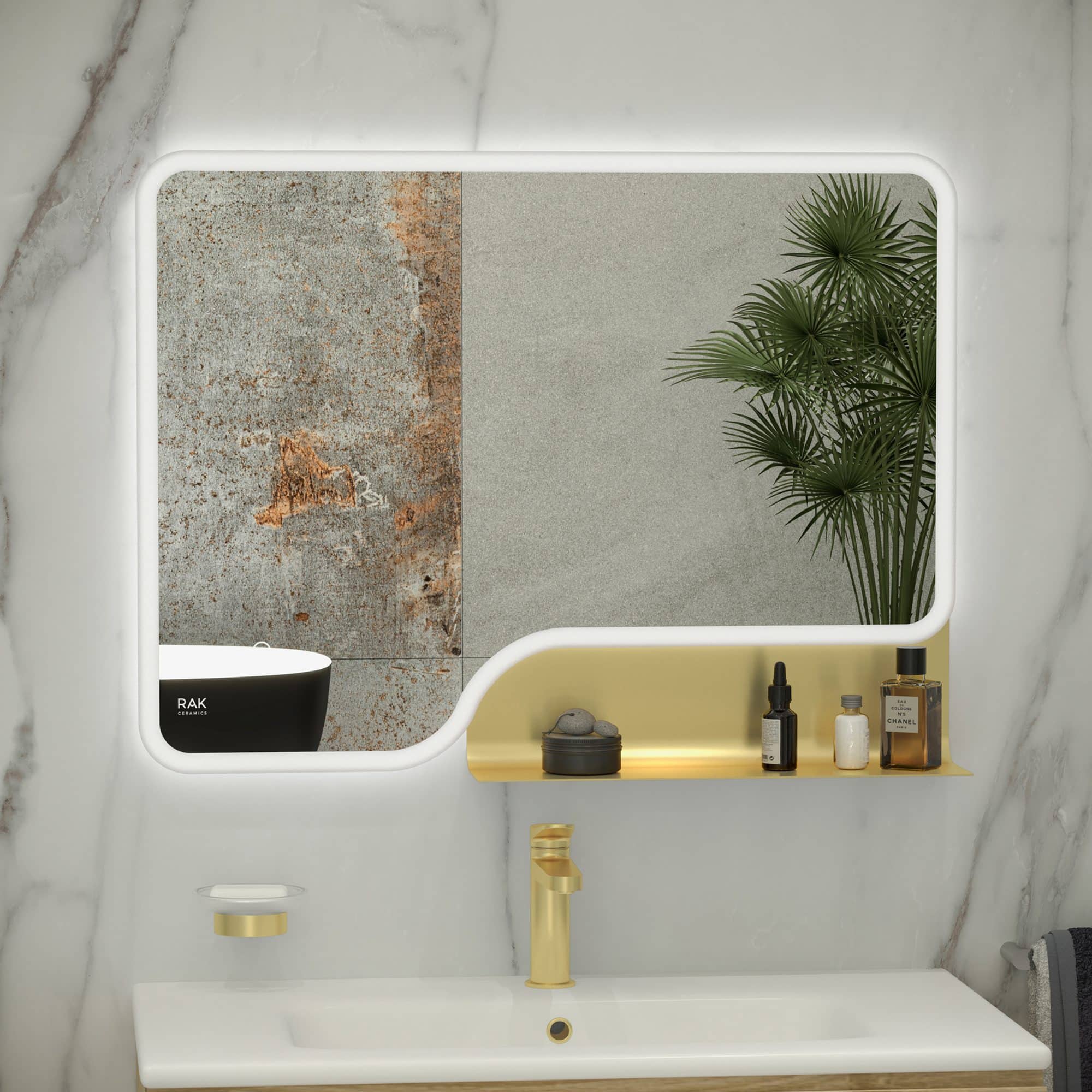 Sleek modern bathroom mirror with integrated LED lighting over a white vanity unit with gold fixtures, reflecting natural stone and textured wall tiles, complemented by stylish decorative toiletries and a green plant.