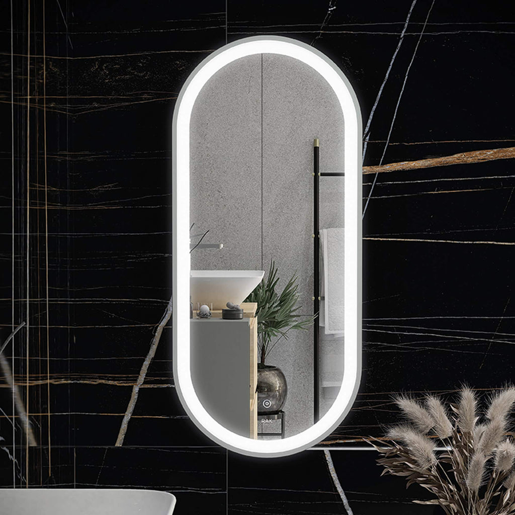 Sleek oval bathroom mirror with LED lighting, modern bathroom decor, against black marble wall with gold veining, reflecting minimalist washbasin and grey textured wall with towel holder.