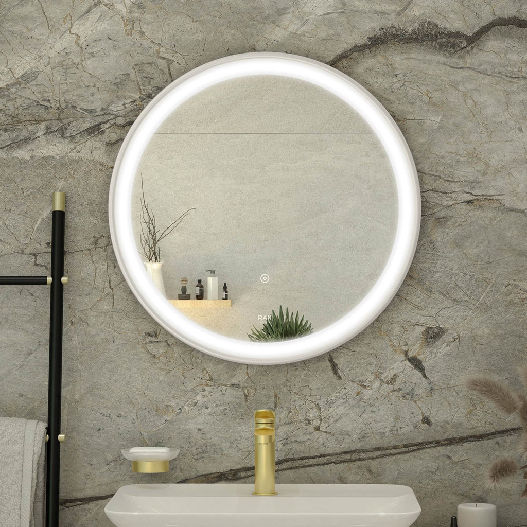 Stylish round illuminated bathroom mirror with LED lighting above a modern sink with a gold faucet, set against a textured grey stone wall, creating a contemporary bathroom aesthetic.
