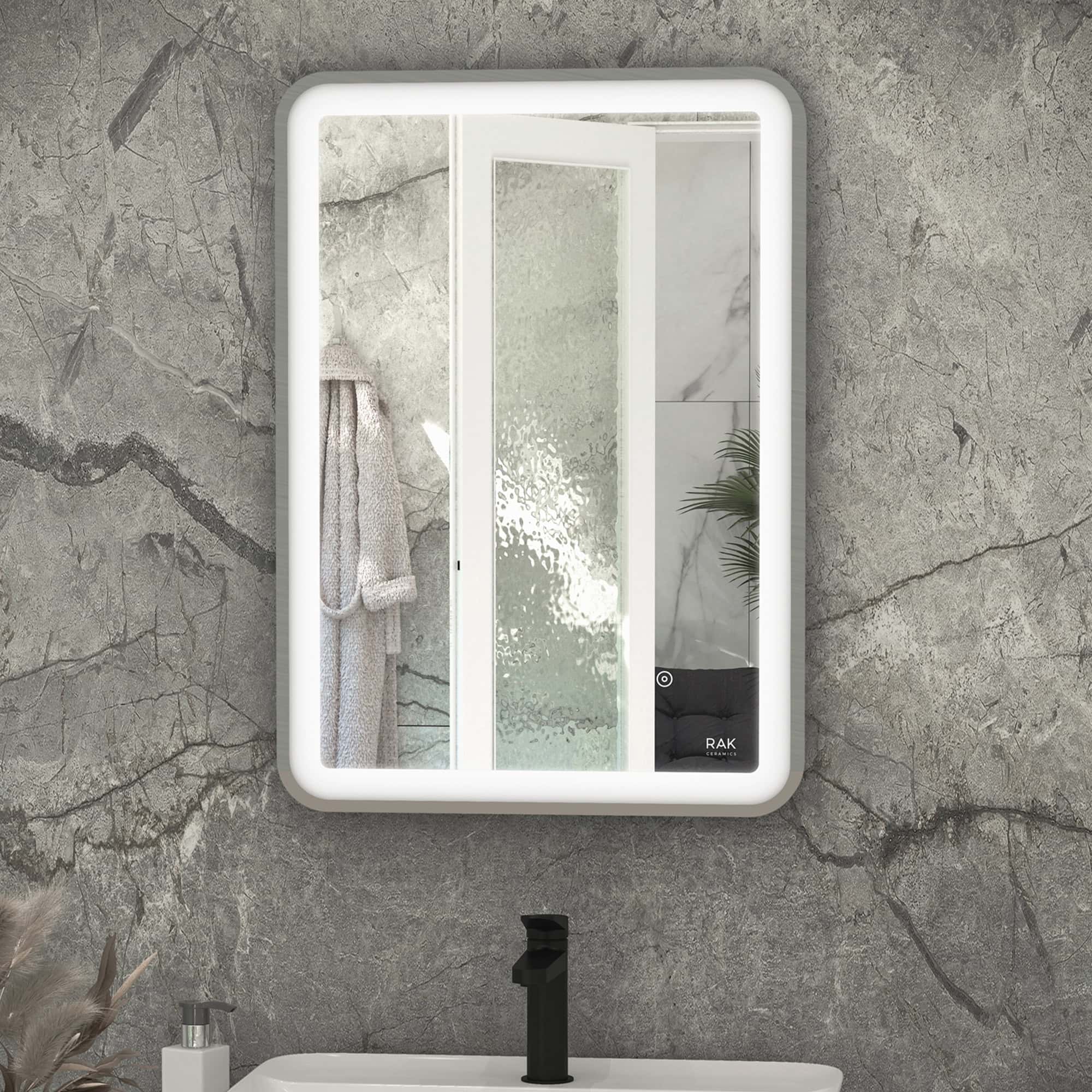 Illuminated modern bathroom mirror with built-in LED lighting, framed layout, sleek design, situated above a contemporary sink with black tap, against textured grey stone wall, ideal for stylish bathroom decor.