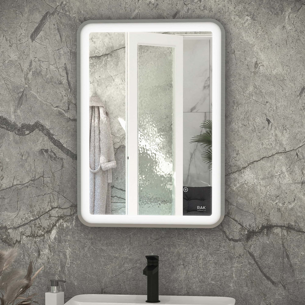 Sleek modern bathroom mirror with built-in LED lighting, framed in white, featuring a touch control panel for convenience, mounted on a stone-textured wall.
