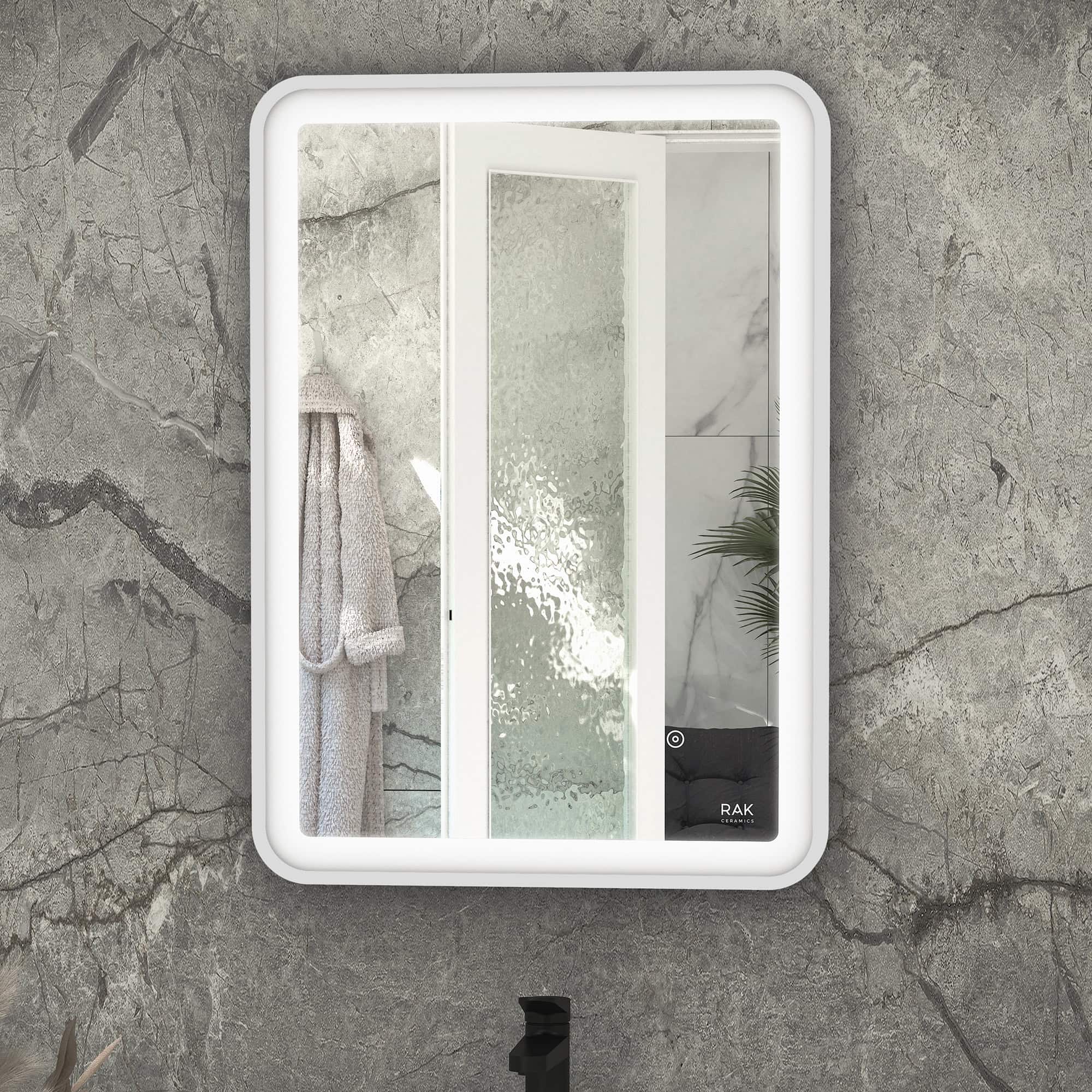Sleek modern bathroom mirror with integrated lighting mounted on textured grey stone wall in contemporary bathroom setting.