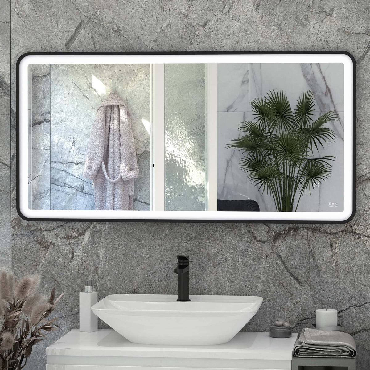 Sleek modern bathroom vanity with a rectangular mirror, marble walls, and a white vessel sink featuring a black faucet, complemented by stylish accessories and lush green plants for a contemporary bathroom design.