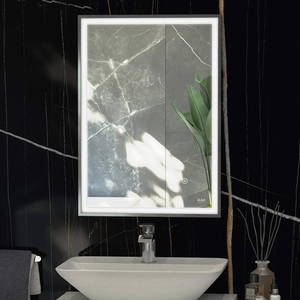 Sleek illuminated bathroom mirror with LED lighting, mounted above a modern white sink on a black marble wall for contemporary bathroom design.