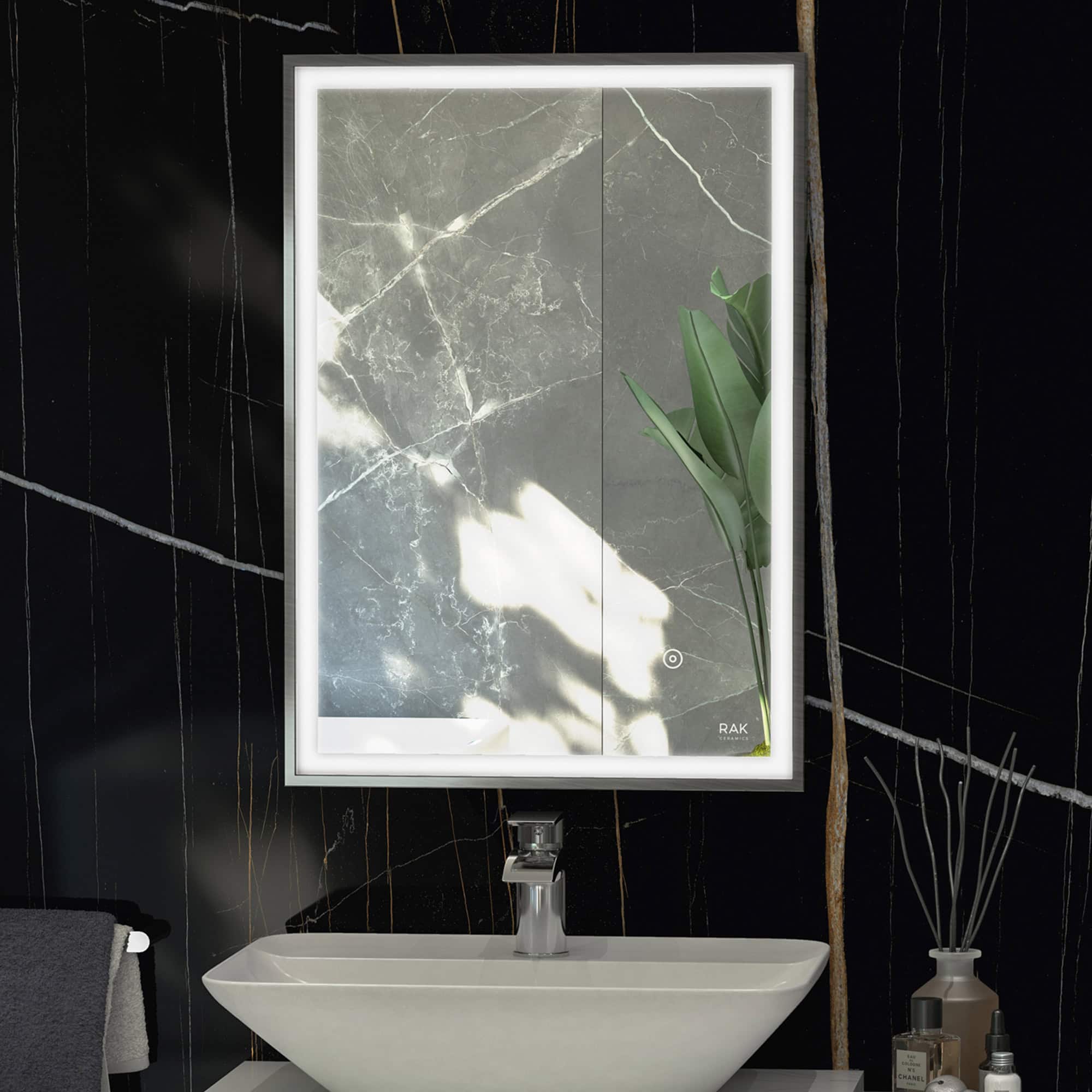 Sleek illuminated bathroom mirror with LED lighting, mounted above a modern white sink on a black marble wall for contemporary bathroom design.