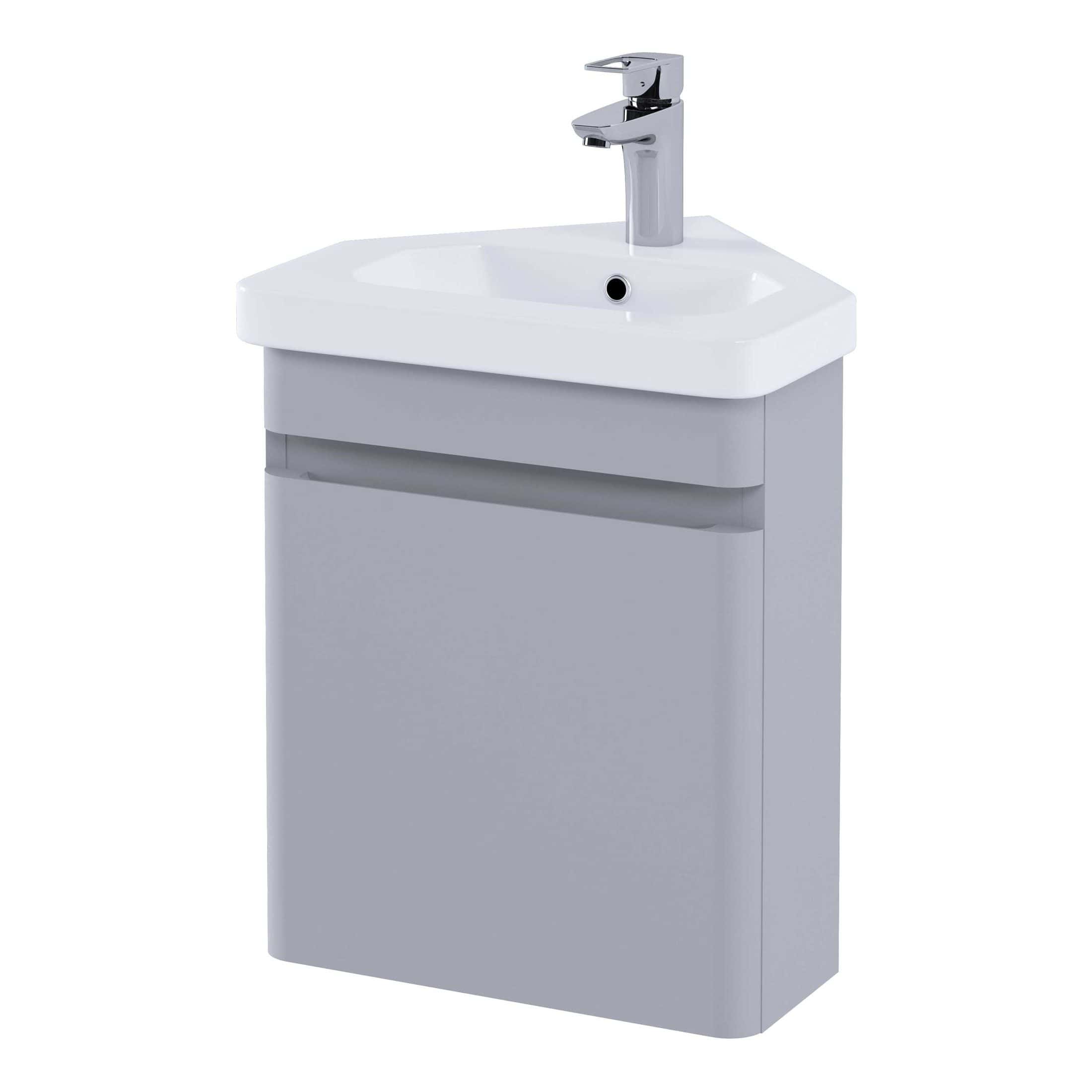 Modern white bathroom sink with sleek chrome tap and storage cabinet, ideal for contemporary bathroom decor.