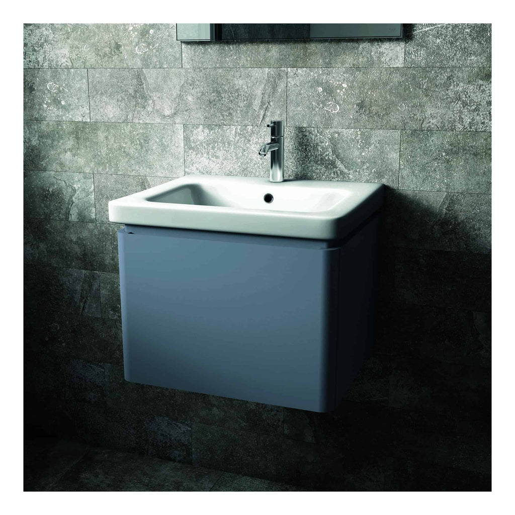 Sleek modern bathroom sink with a blue cabinet, mounted on a stone tiled wall, featuring a chrome tap for contemporary bathroom vanity, ideal for bathroom renovation projects.