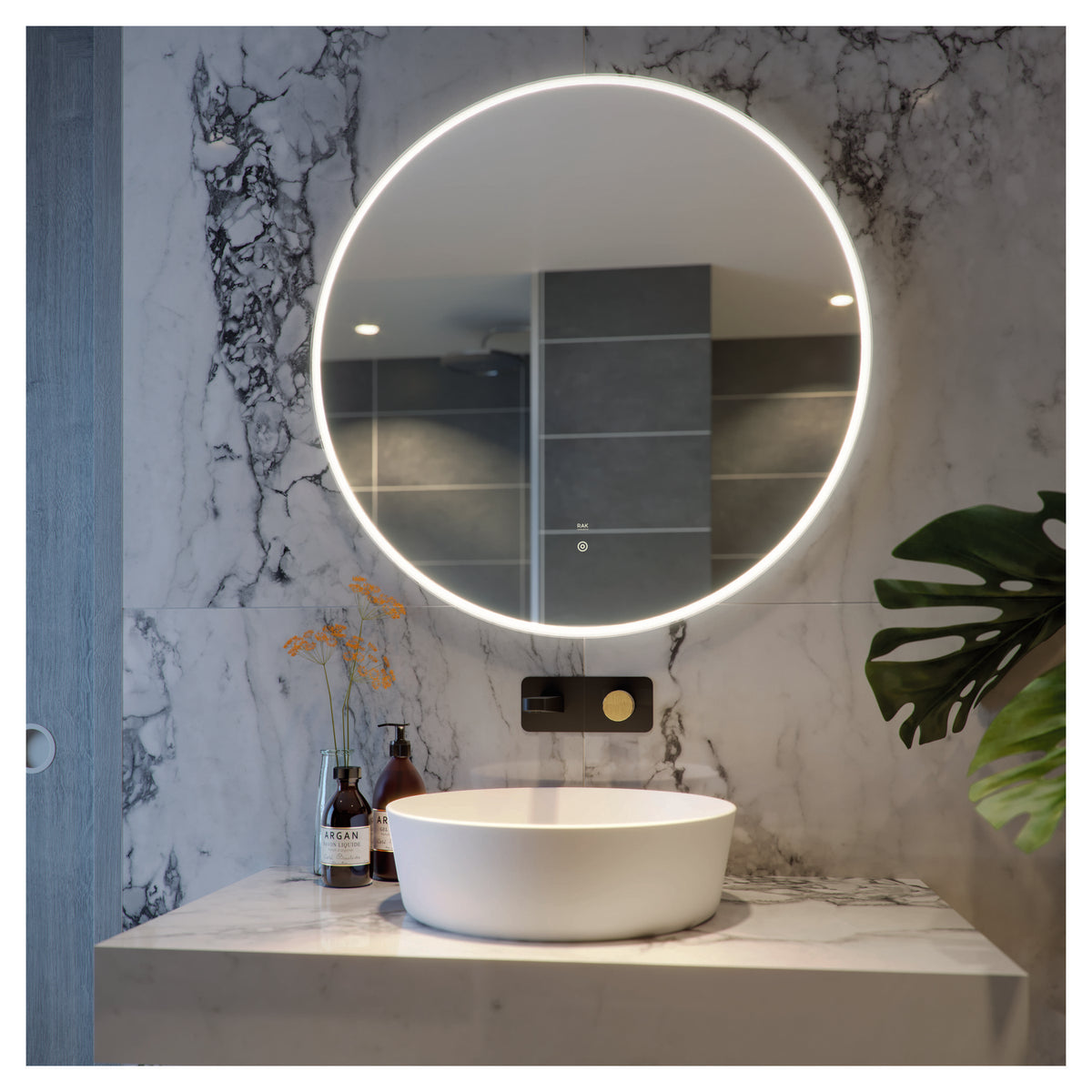 Sleek modern bathroom with illuminated round mirror, marble countertop, and stylish accessories, showcasing luxury bathroom design by Bubly Bathrooms.