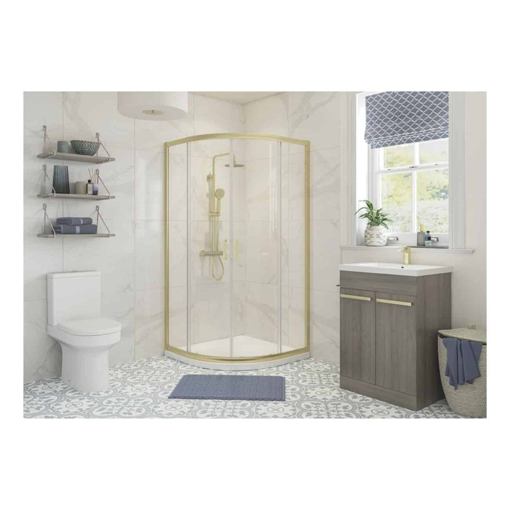 Bright modern bathroom featuring a corner shower with gold accents, a sleek grey vanity, and decorative blue towels and accessories, perfect for contemporary bathroom design.