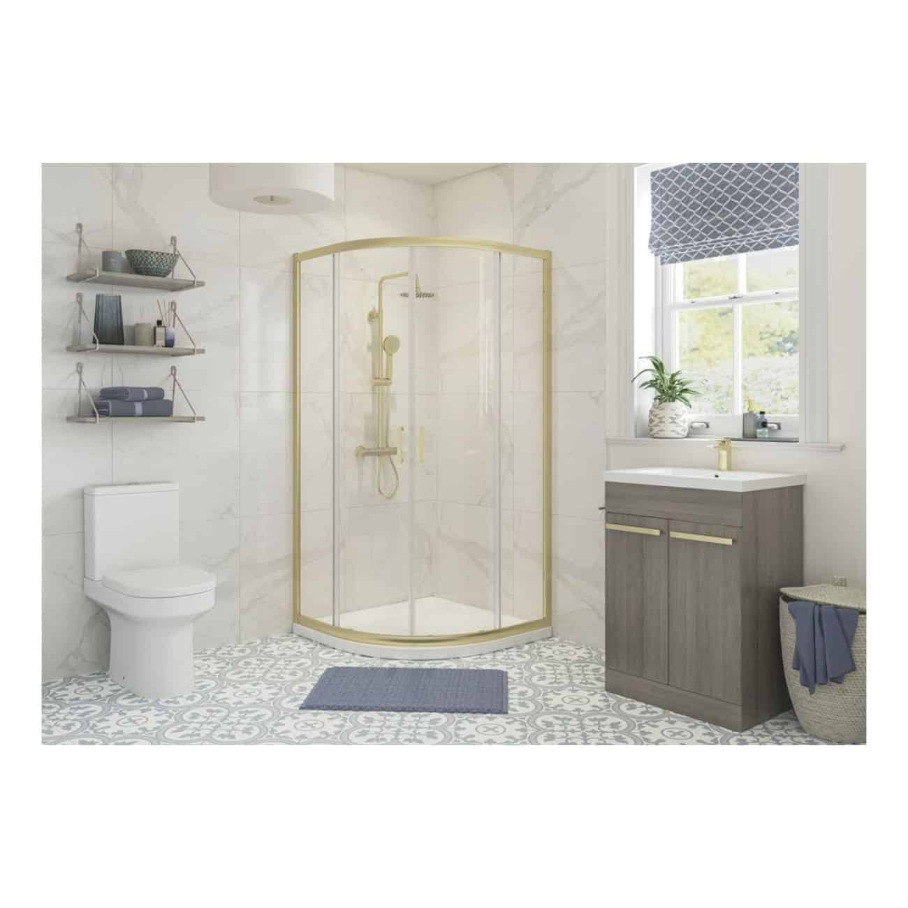 Bright modern bathroom featuring a corner shower with gold accents, a sleek grey vanity, and decorative blue towels and accessories, perfect for contemporary bathroom design.
