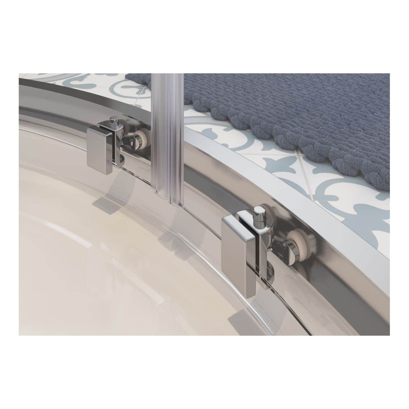 Modern shower enclosure with sliding glass door and polished chrome hardware, installed on decorative tile floor with a soft grey towel, showcasing contemporary bathroom design.