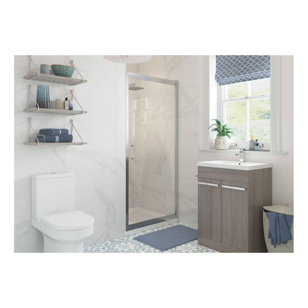 Bright modern bathroom featuring a walk-in shower with glass door, white toilet, light wood vanity with sink, shelves with towels, a window with patterned blind, and stylish blue accents, perfect for contemporary bathroom design.