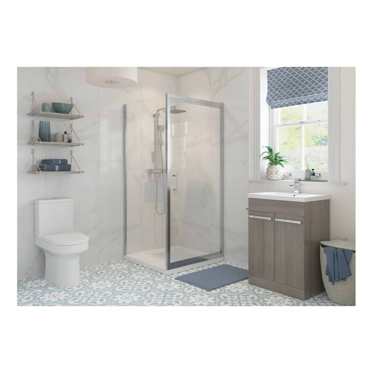 Contemporary bathroom featuring a glass shower enclosure, modern vanity with sink, toilet, and stylish decor with blue accents and a patterned floor, perfect for luxury bathroom design.