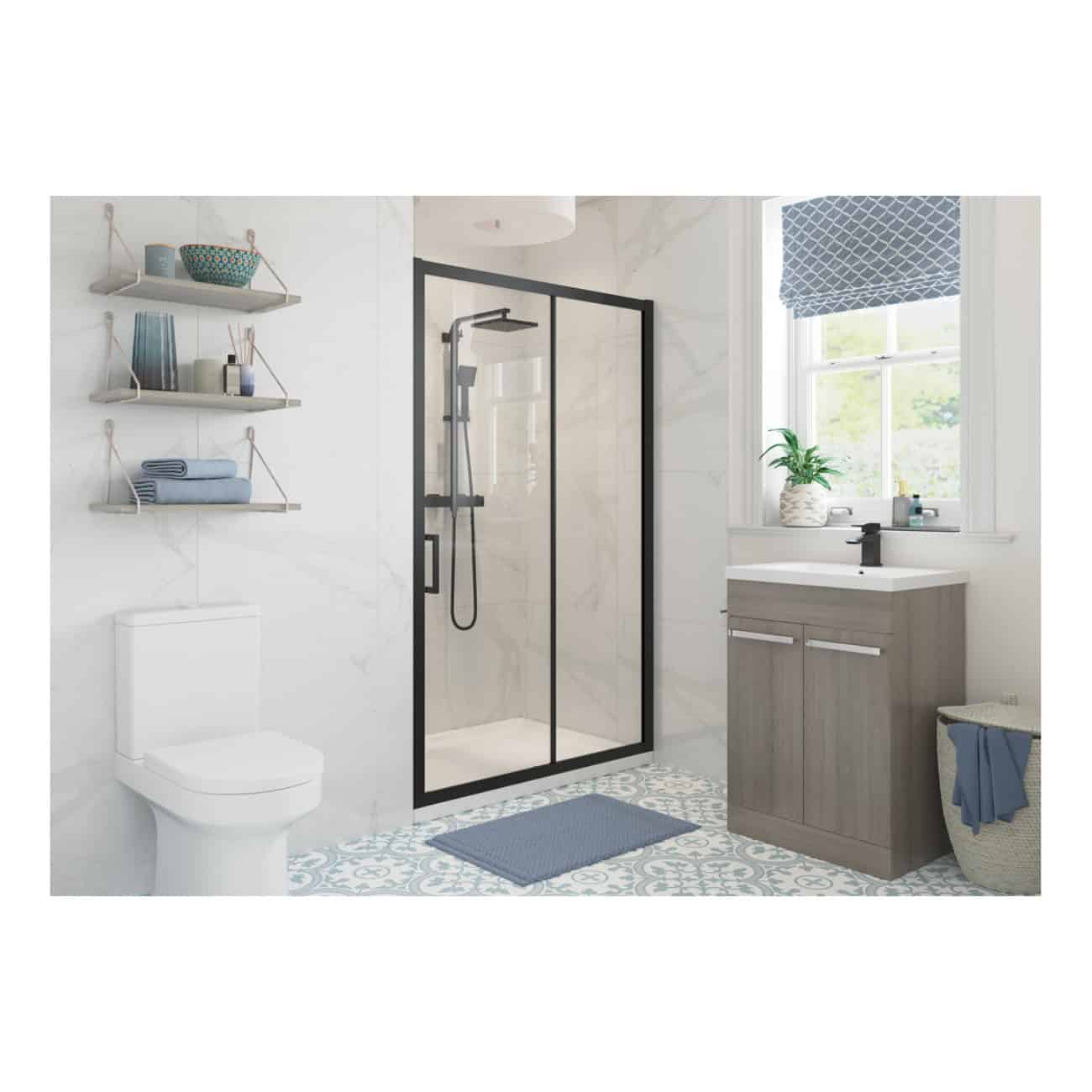 Modern bathroom with walk-in shower, grey vanity unit, white toilet, blue accents, decorative shelving, patterned floor tiles, and a large window with blue roller blind.