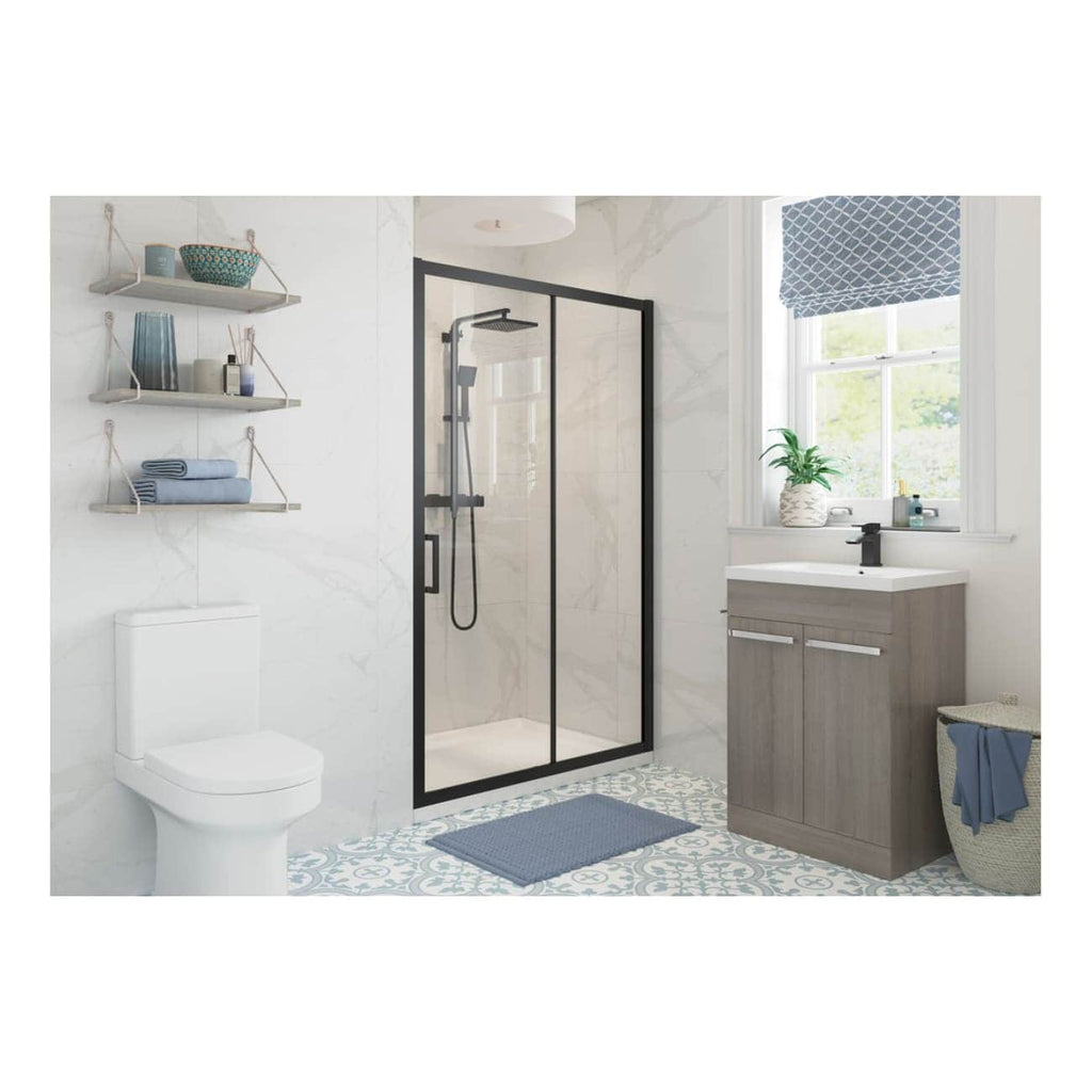 Sleek modern bathroom featuring a walk-in shower with black frame, wooden vanity with white basin, white toilet, and decorative blue accents, creating a fresh and stylish space.