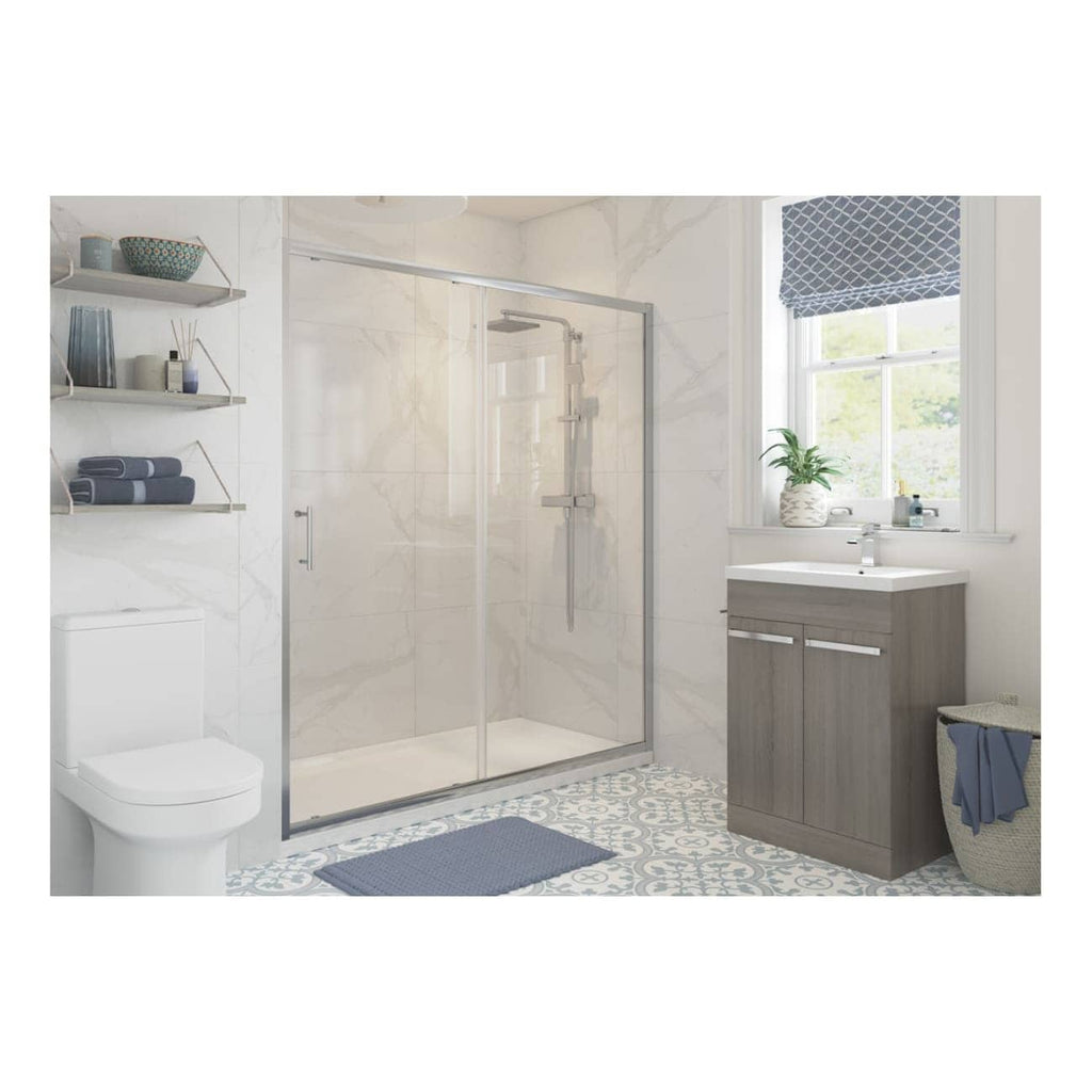 Modern bathroom with a glass shower enclosure, wooden vanity with white sink, patterned blue and white floor tiles, and contemporary decor including towels, plants, and accessories for a stylish bathroom design.