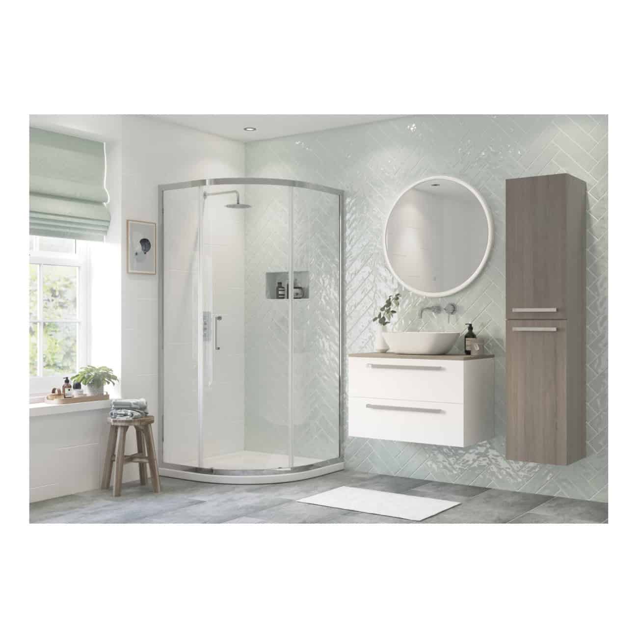 Modern bathroom with a glass shower enclosure, white vanity with vessel sink, large illuminated round mirror, grey wall cabinet, and natural light from a window. Stylish and functional bathroom design.