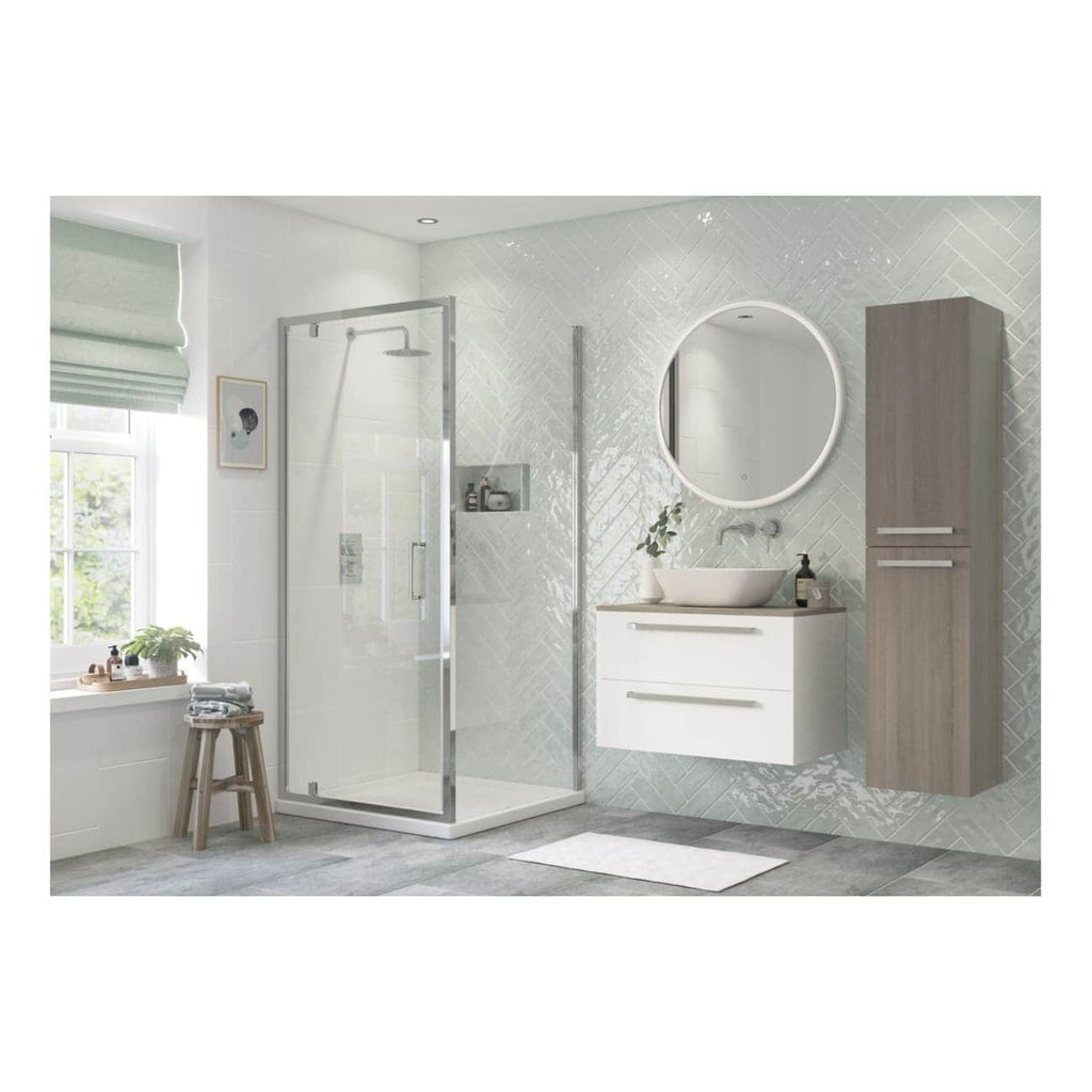 Modern minimalist bathroom with walk-in shower, wall-mounted vanity sink, large round mirror, tall wooden storage cabinet, natural light, and neutral tones for a sleek, contemporary bathroom design.