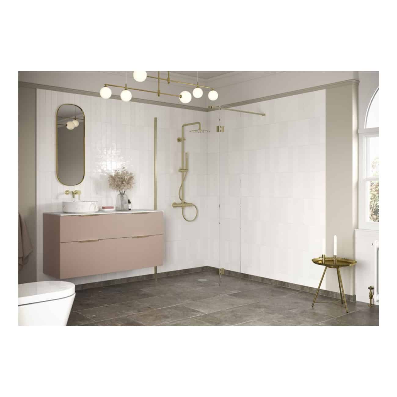 Modern minimalist bathroom with a wall-mounted vanity, oval mirror, golden shower fixtures, contemporary lighting, and neutral tones for a stylish, functional space.