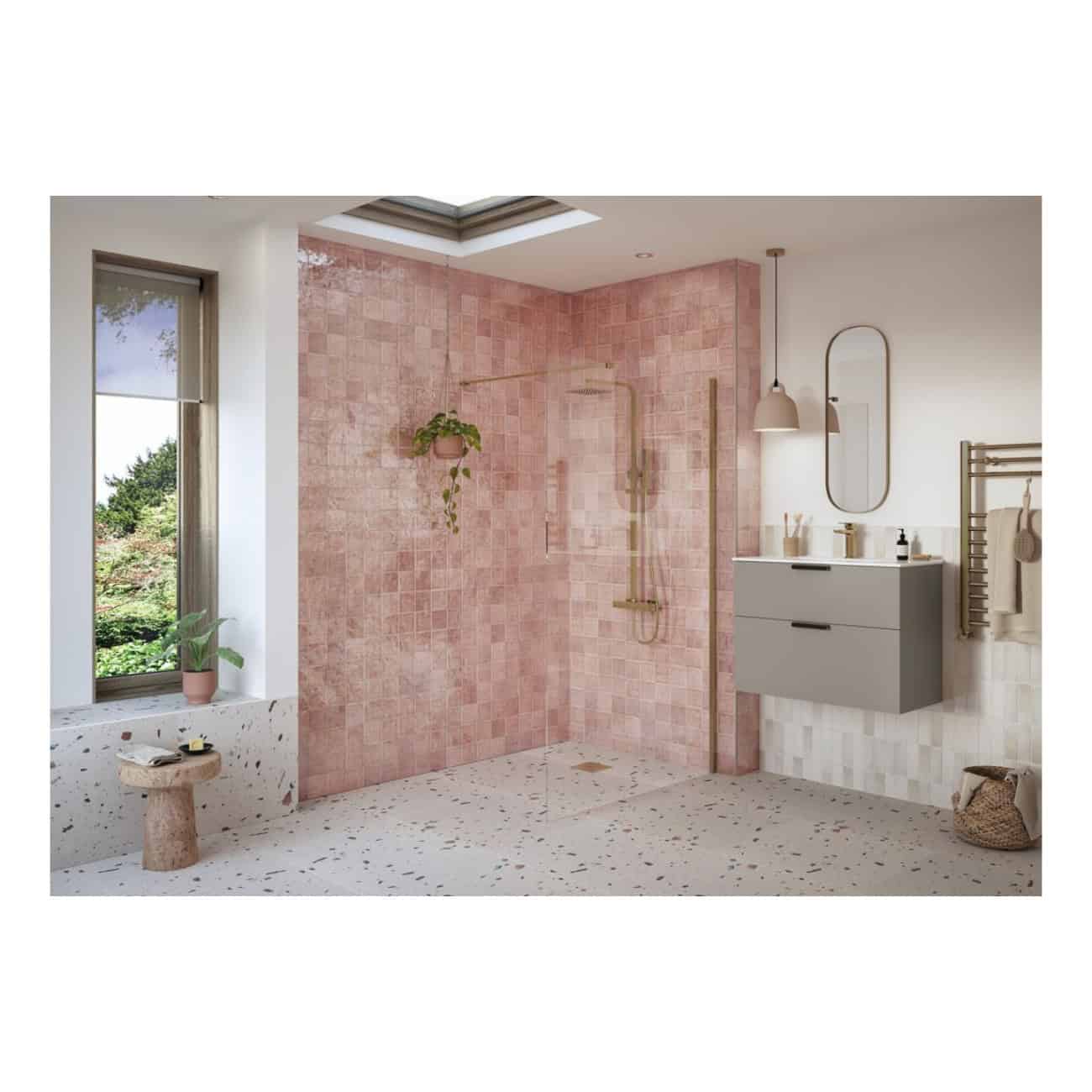 Vibrant pink tiled walk-in shower with sleek gold fixtures in a modern, minimalist bathroom featuring natural light and stylish decor.