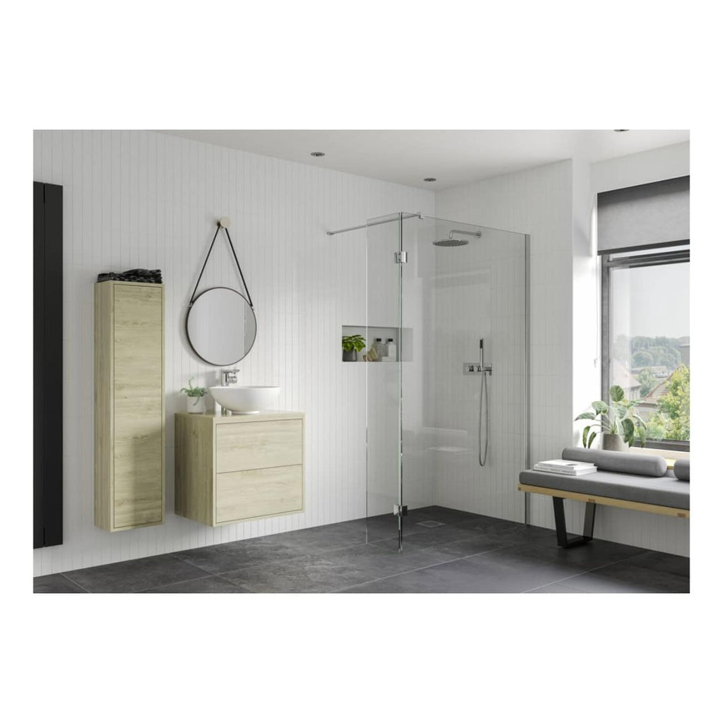 Sleek modern bathroom with a walk-in glass shower, minimalist light wood vanity units, wall-mounted round mirror, and natural light from large window, creating a calming spa-like atmosphere.