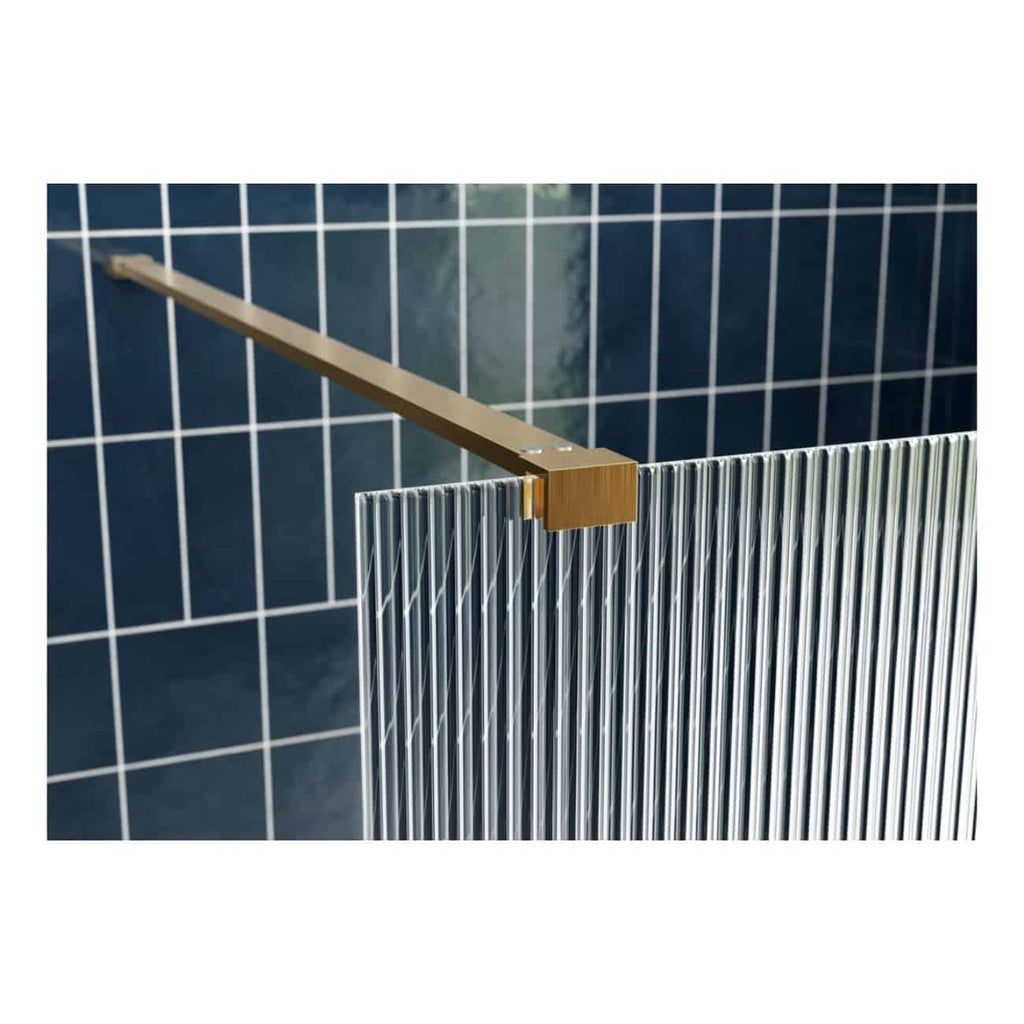Sleek metal bathroom radiator with vertical bars, mounted on a modern blue tiled wall, blending functionality and contemporary design for a stylish bathroom setting.