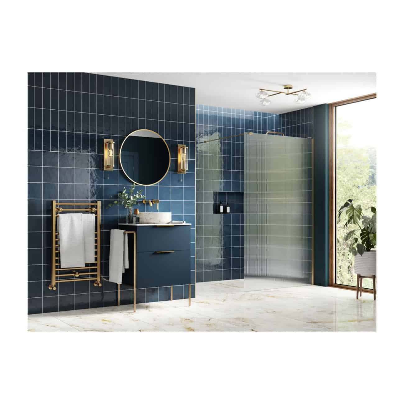 Lavender blue tiled bathroom with modern vanity, round mirror, gold accents, walk-in shower, large window, and marble flooring, creating a stylish and luxurious bathroom design.