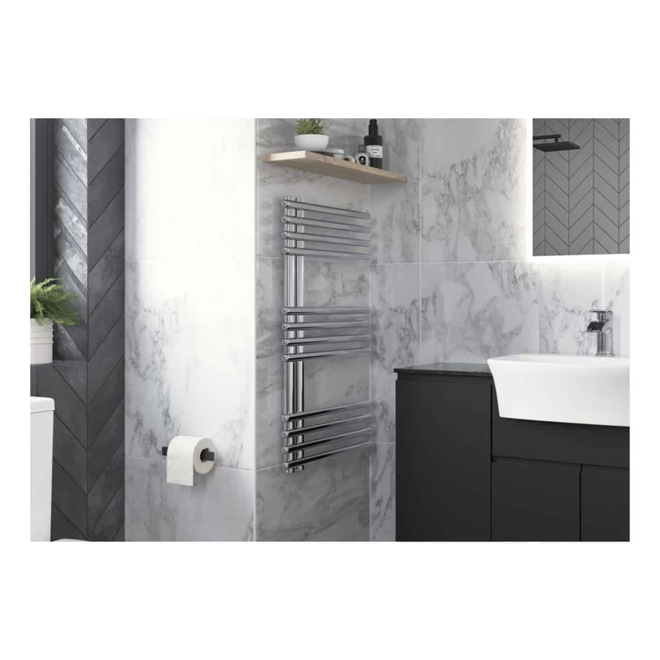 Sleek modern bathroom featuring marble wall tiles, chrome heated towel rail, black vanity unit, wall-mounted mirror with LED lighting, and contemporary accessories, perfect for stylish bathroom renovation.