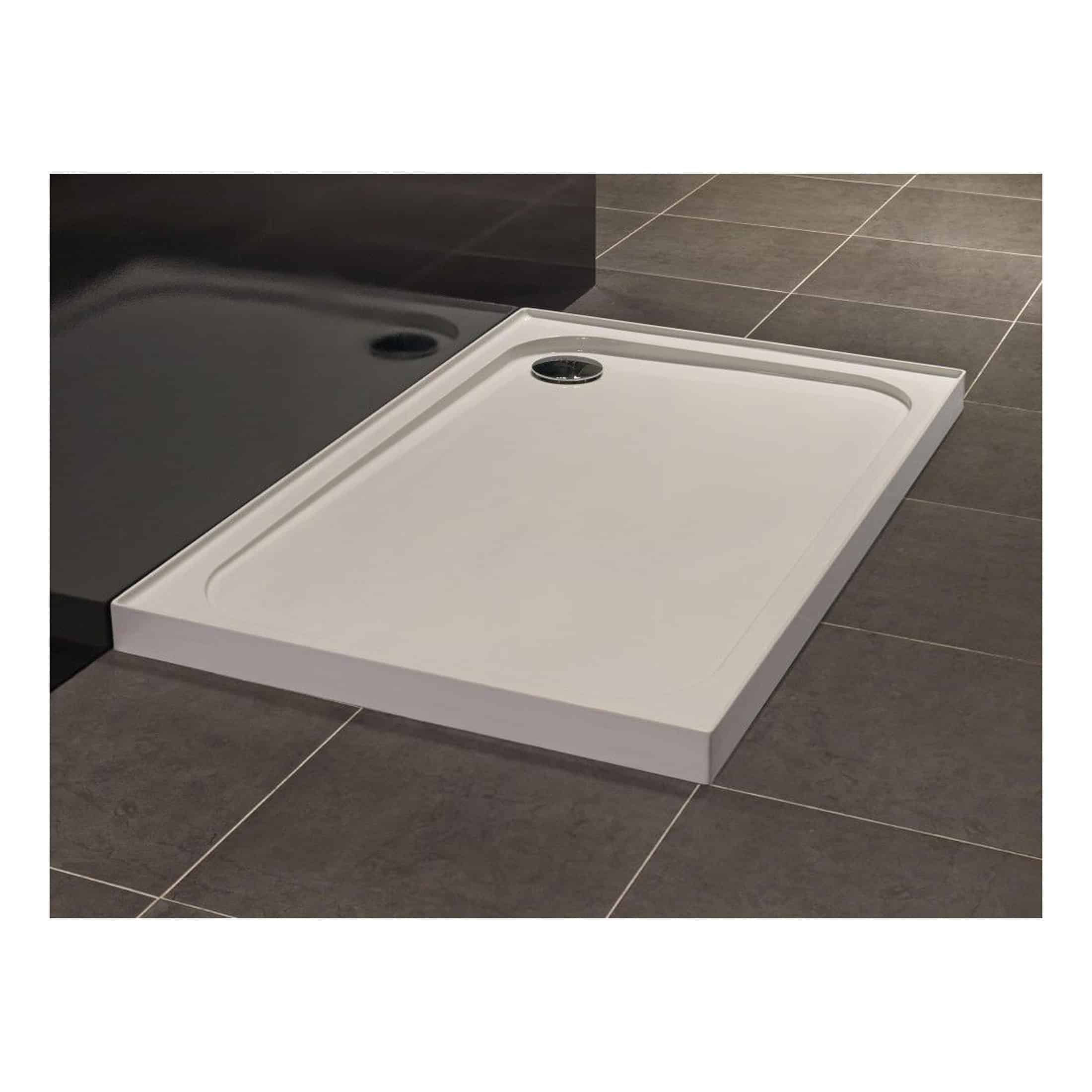 Modern white shower tray with a built-in drain and slightly raised edges, designed for contemporary bathroom installations, providing a sleek and functional shower area.