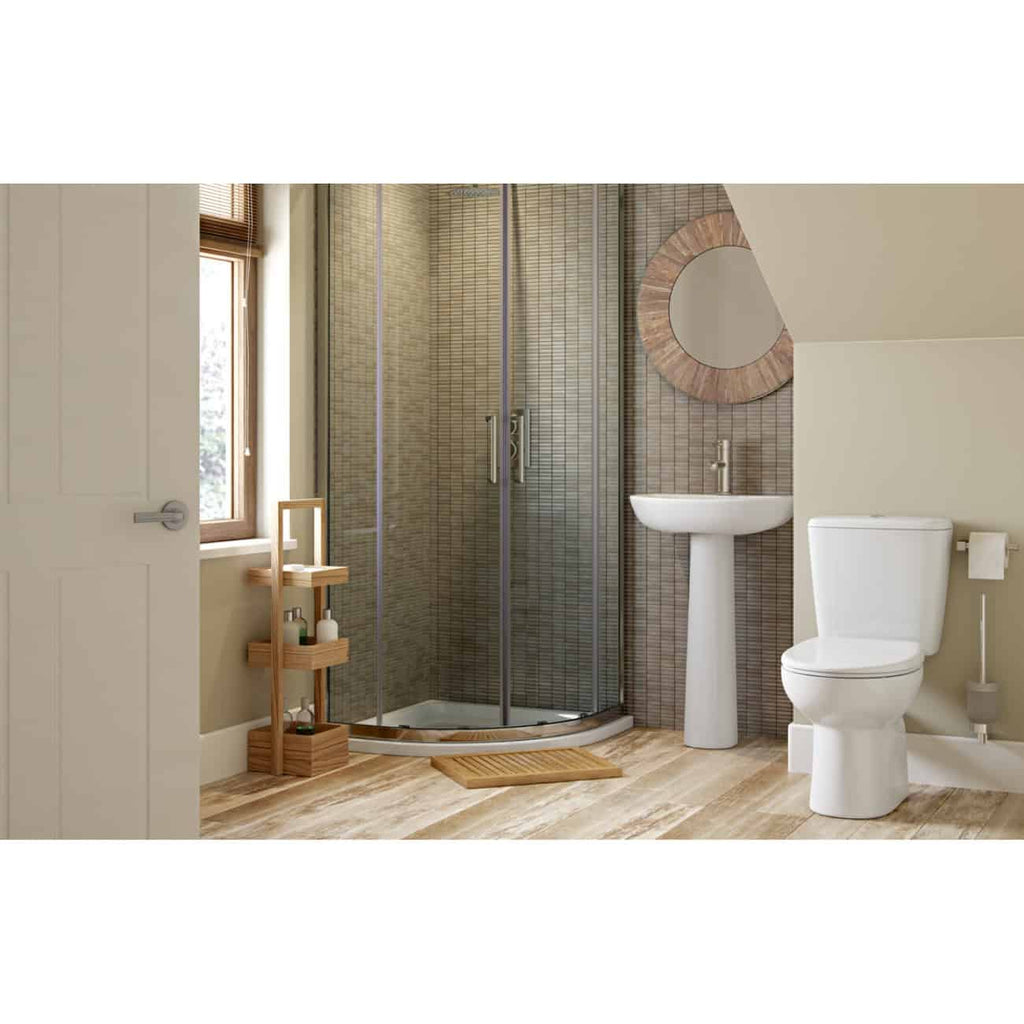 Luxurious bathroom with a modern glass shower, pedestal sink, and eco-friendly wooden accessories, featuring neutral tones and natural light for a stylish and functional space.